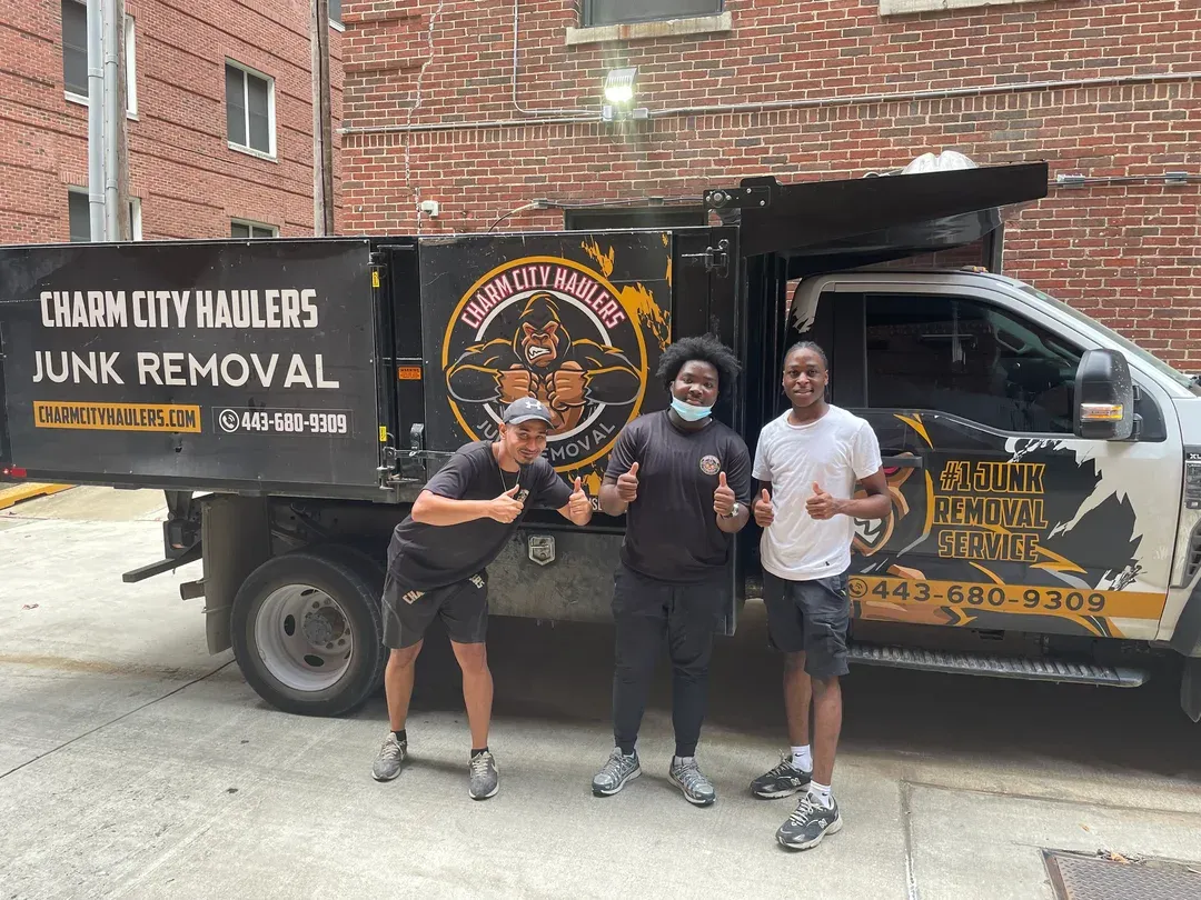 Charm City Haulers crew with their junk removal truck in Baltimore